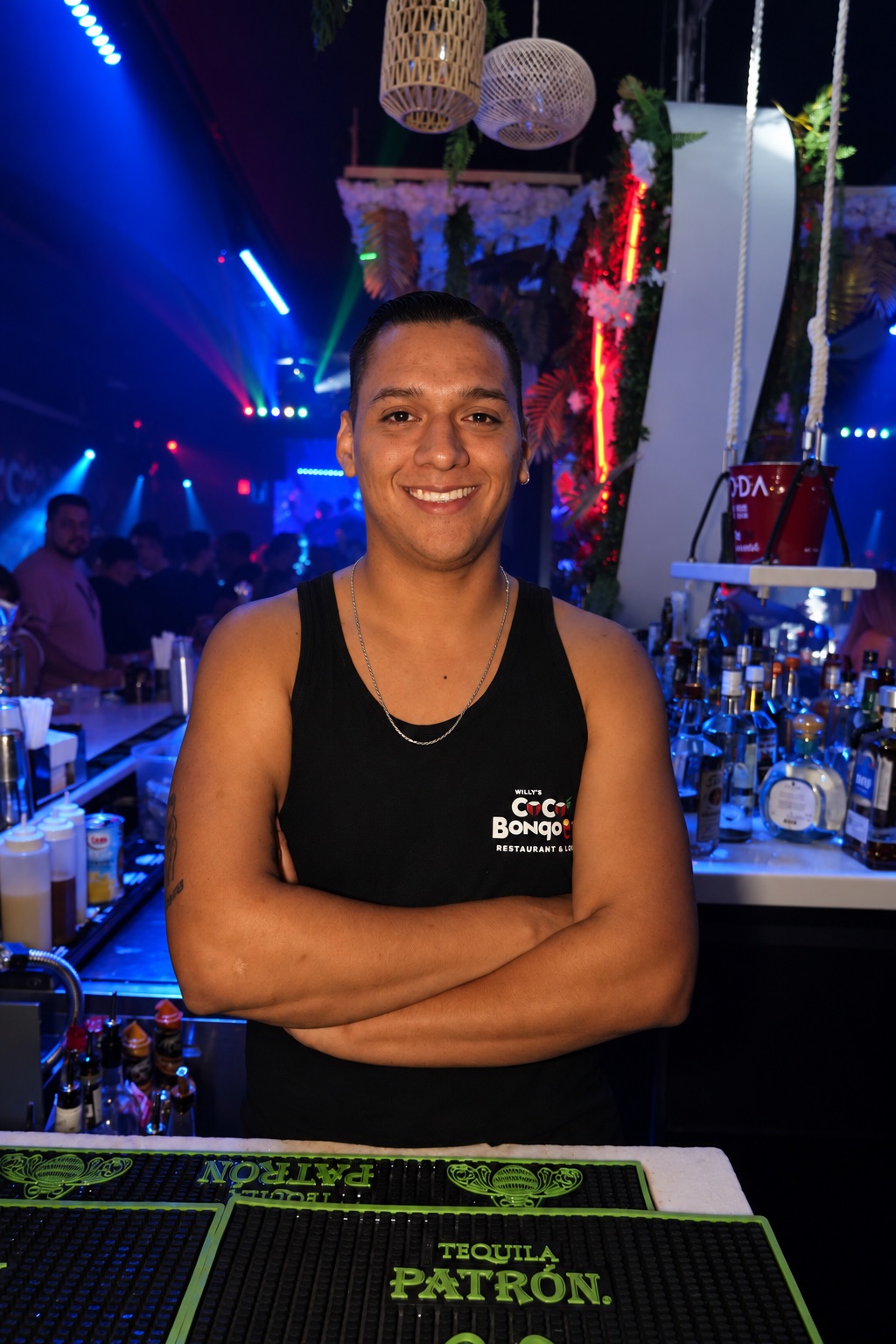 Coco Bongo team member behind the bar